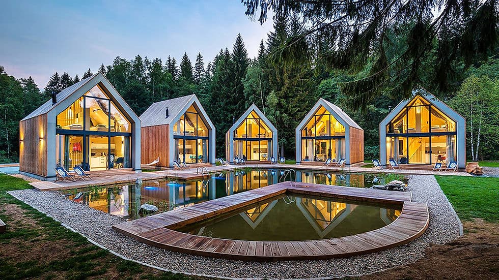 Prefab micro bungalow with floor-to-ceiling glazing and timber deck